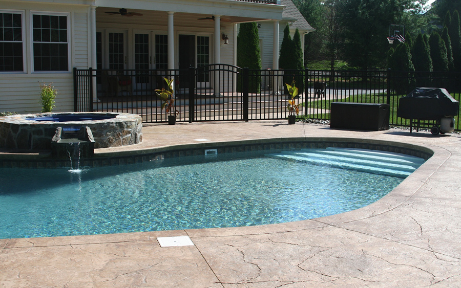 Backyard fencing project tied into a pool and patio installation